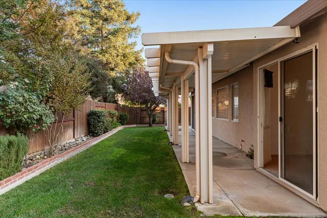 a view of a porch with a big yard and potted plants