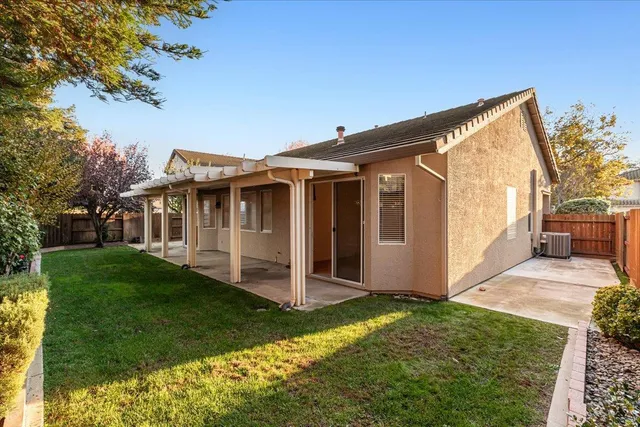 a view of backyard of house with green space
