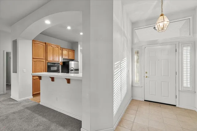 a view of kitchen with stainless steel appliances granite countertop cabinets and window
