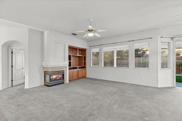 an empty room with furniture and a fireplace