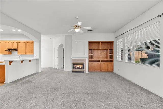 a view of a kitchen with refrigerator and a sink