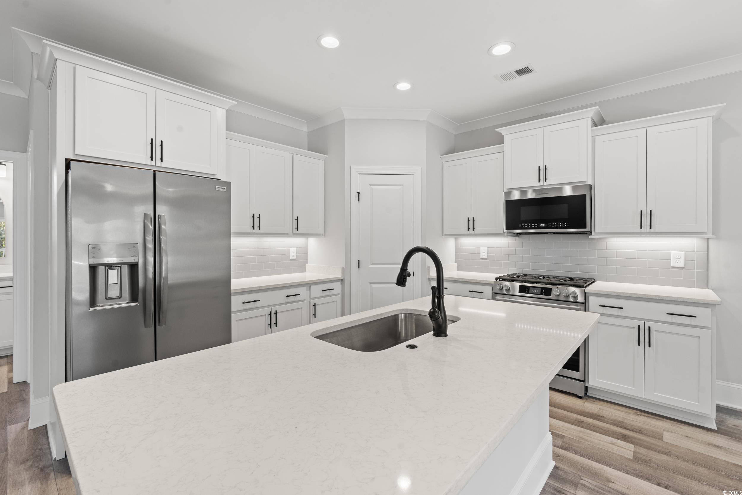 16 Mullet Bay Road Pawleys Island, SC 29585 - Photo 8 of 38 Kitchen with light hardwood / wood-style floors, a
