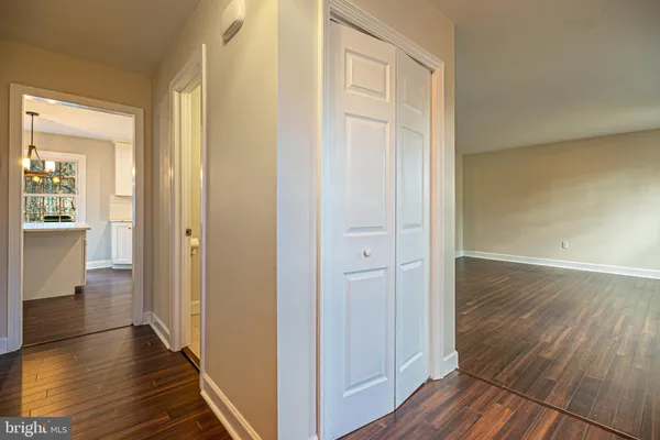 a view of a hallway with wooden floor