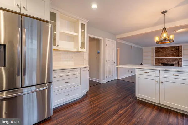 a kitchen with stainless steel appliances granite countertop a refrigerator and a stove top oven