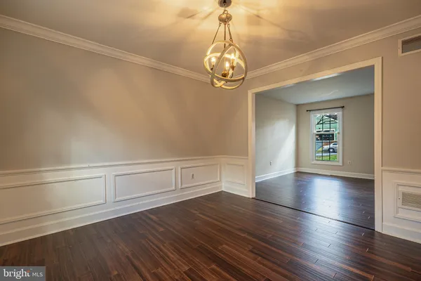 a view of room with window and wooden floor