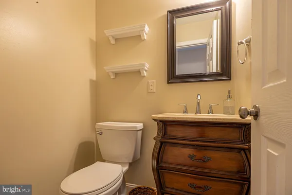a bathroom with a toilet a sink and mirror