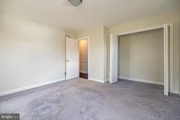 an empty room with closet area