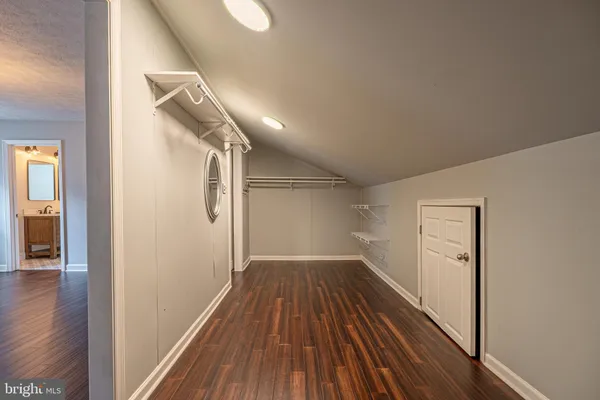 a view of hallway with wooden floor