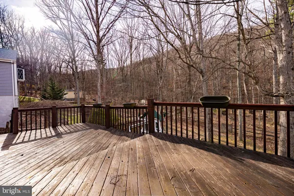 a balcony with wooden floor and fence