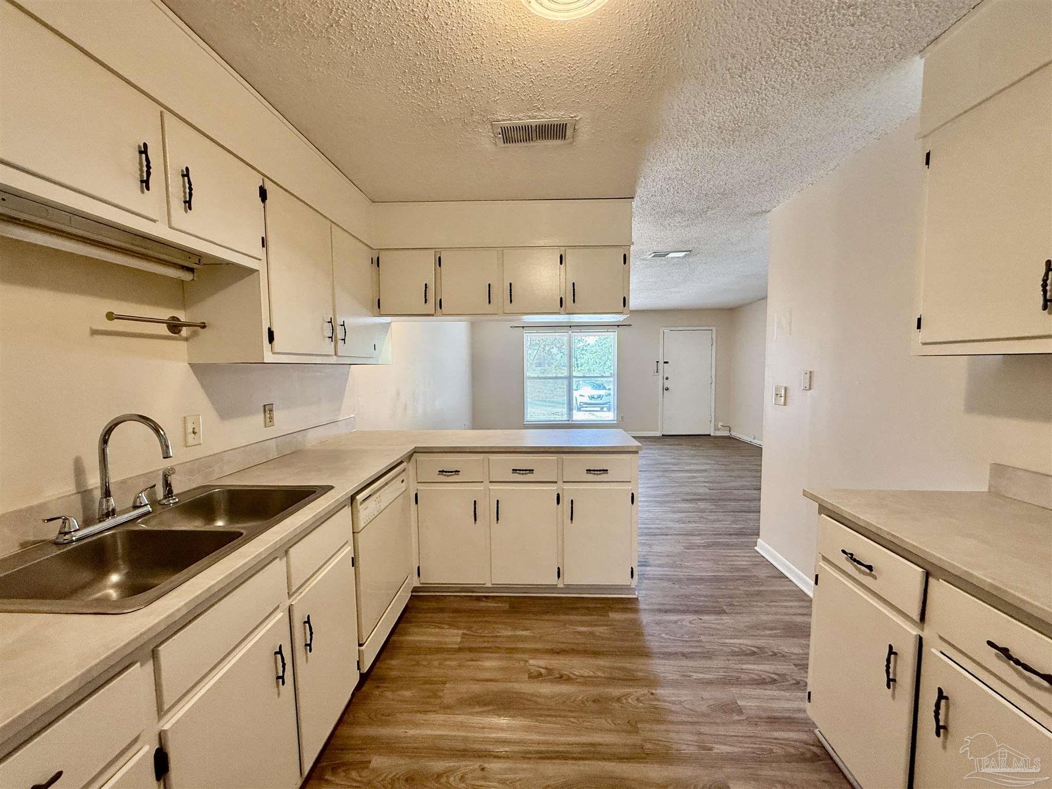 3226 Santa Rosa Drive Gulf Breeze, FL 32563 - Photo 1 of 15 a kitchen with sink a stove and cabinets