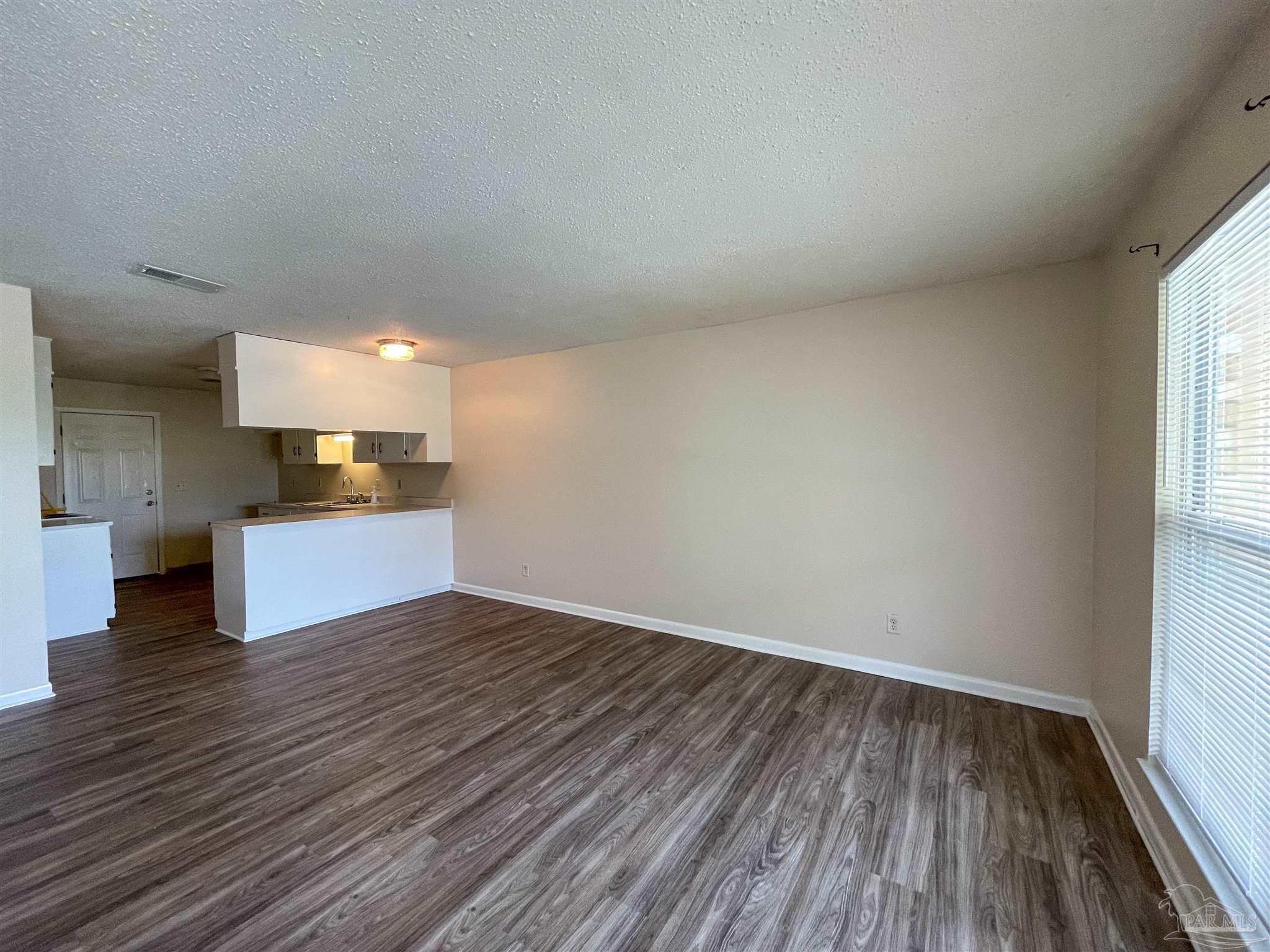 a view of kitchen and wooden floor