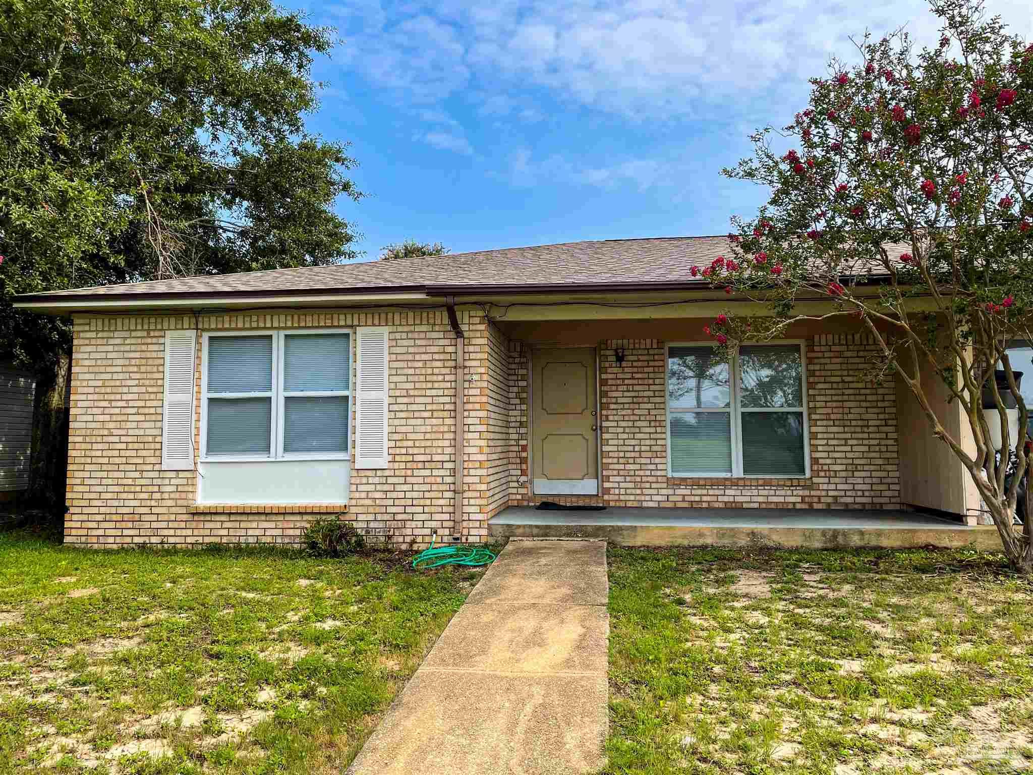 a front view of a house with garden