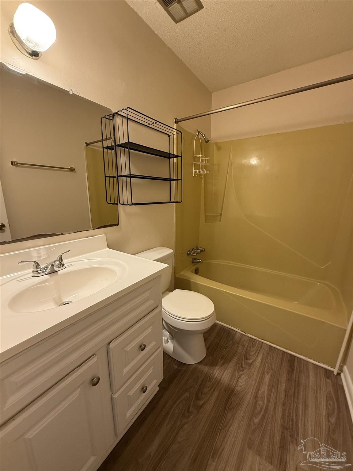 3226 Santa Rosa Drive Gulf Breeze, FL 32563 - Photo 13 of 15 a bathroom with a granite countertop sink a toilet and shower