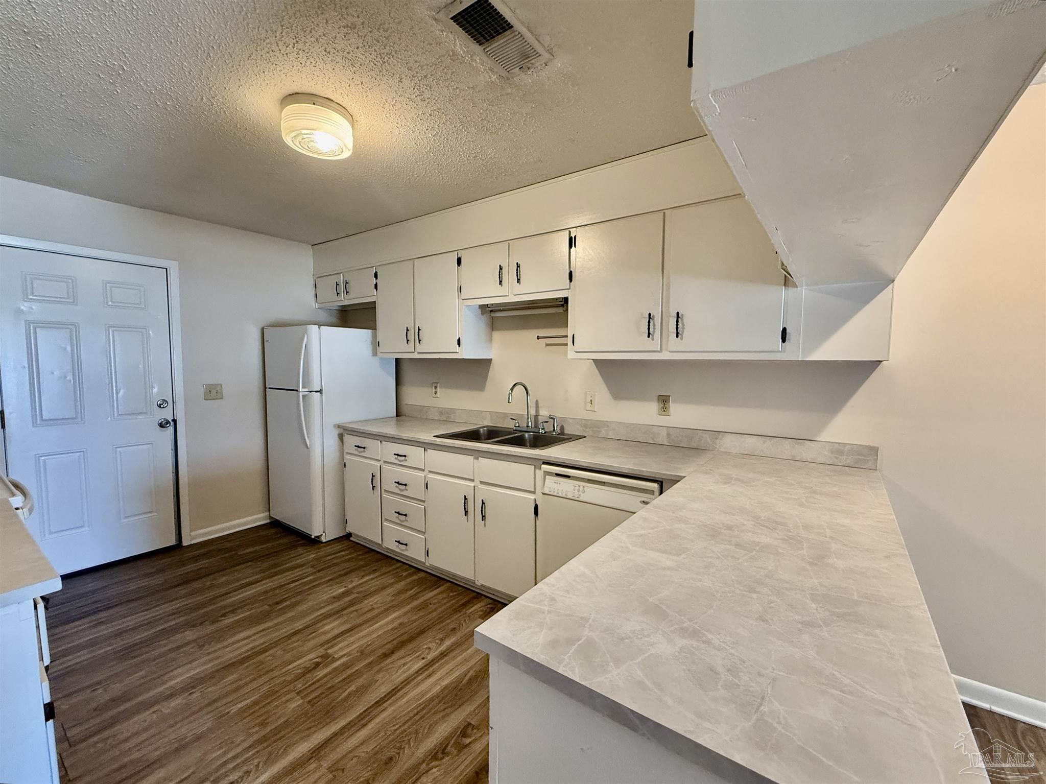 3226 Santa Rosa Drive Gulf Breeze, FL 32563 - Photo 2 of 15 a kitchen with stainless steel appliances granite countertop a sink stove and refrigerator