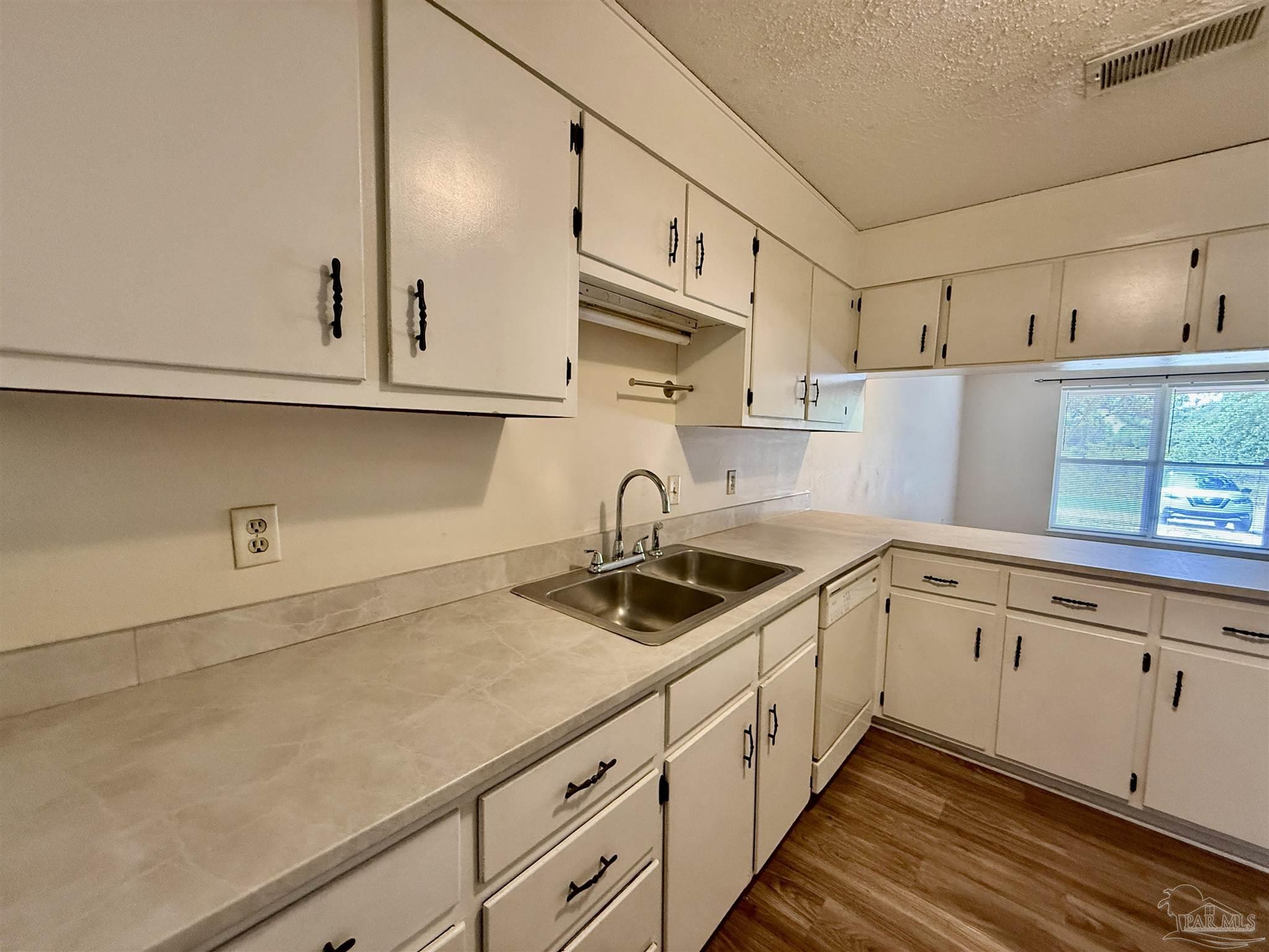 3226 Santa Rosa Drive Gulf Breeze, FL 32563 - Photo 3 of 15 a kitchen with granite countertop white cabinets and sink