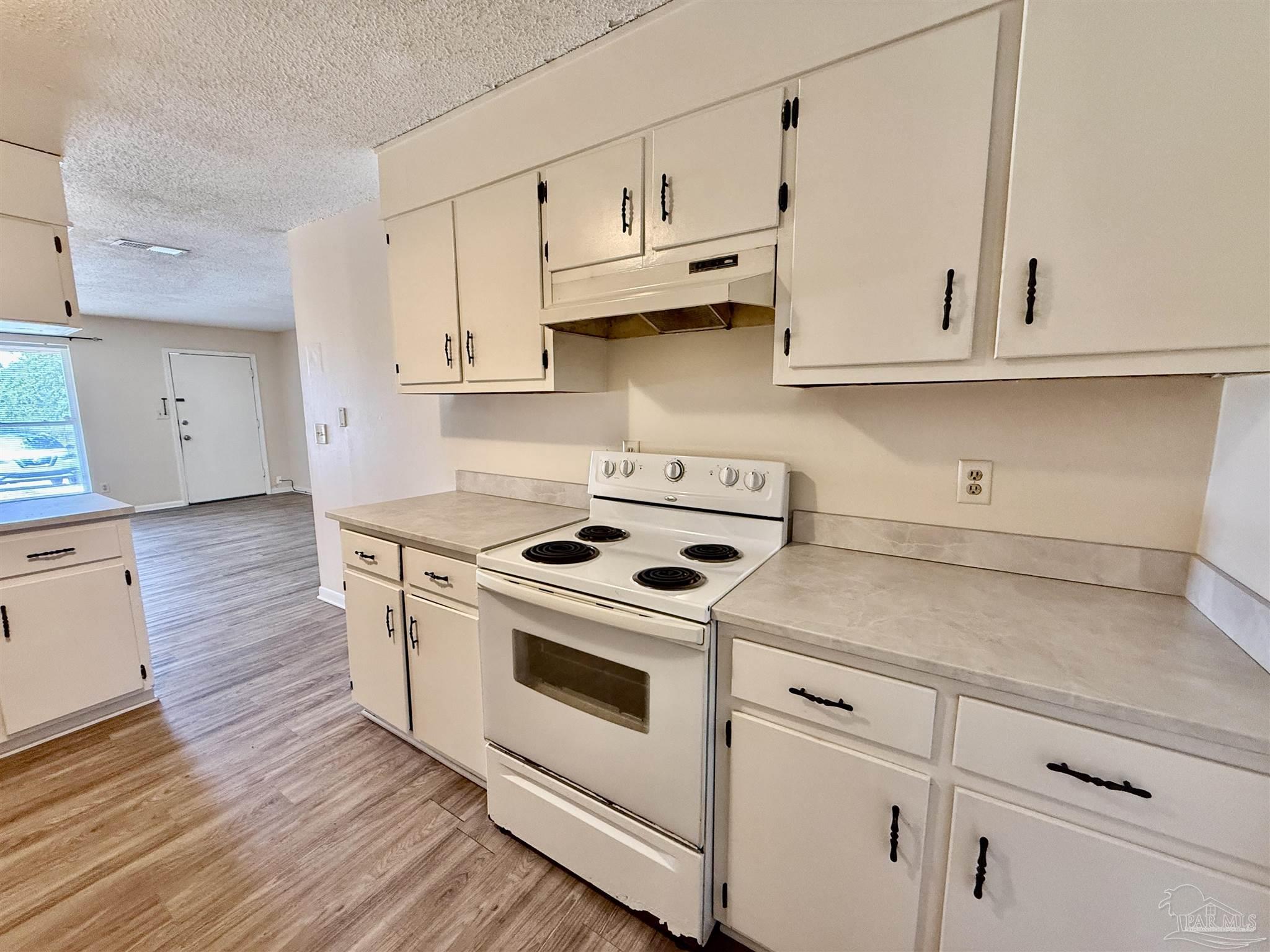 3226 Santa Rosa Drive Gulf Breeze, FL 32563 - Photo 4 of 15 a kitchen with granite countertop white cabinets and white appliances