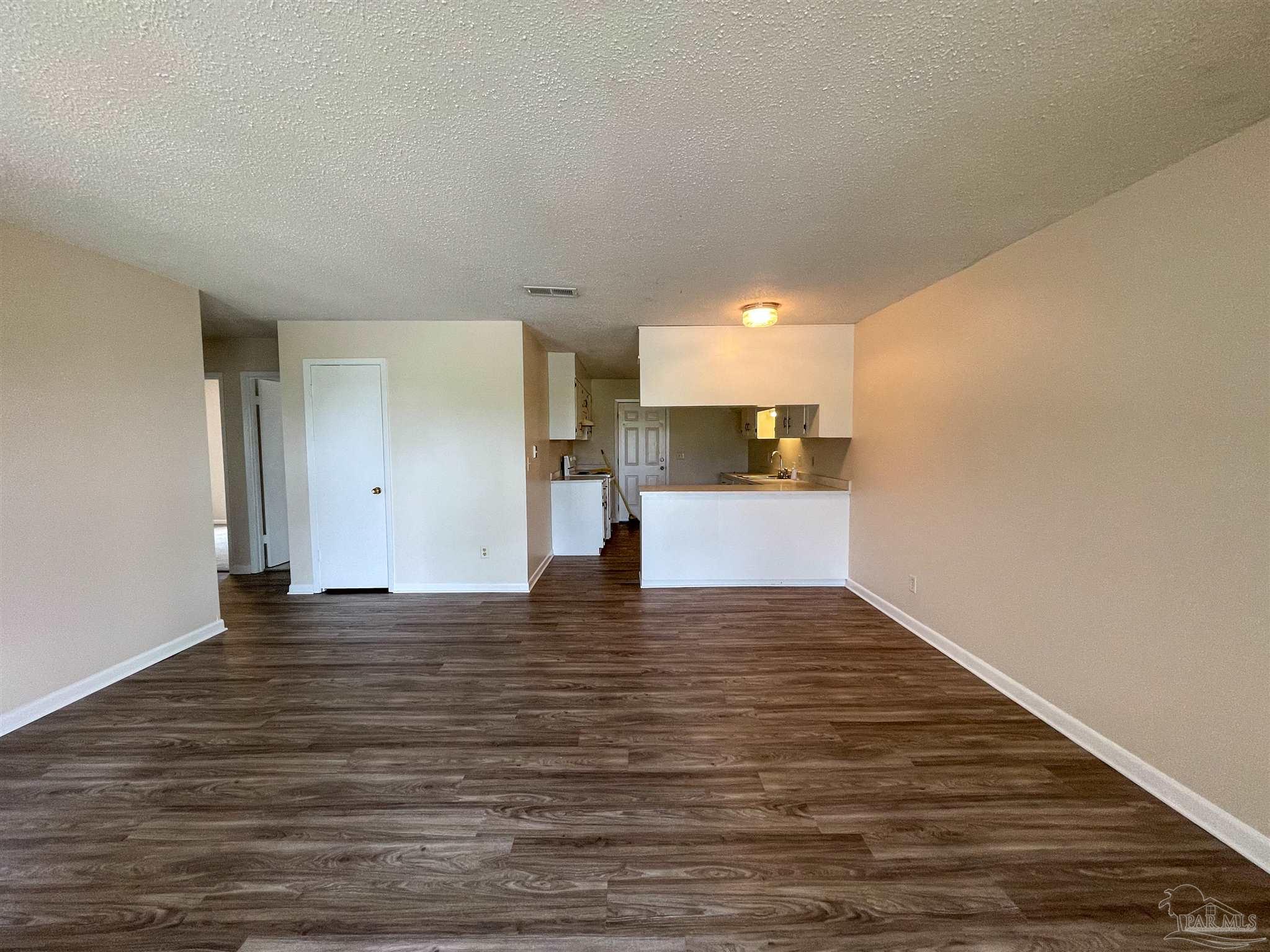 3226 Santa Rosa Drive Gulf Breeze, FL 32563 - Photo 5 of 15 a view of empty room with wooden floor