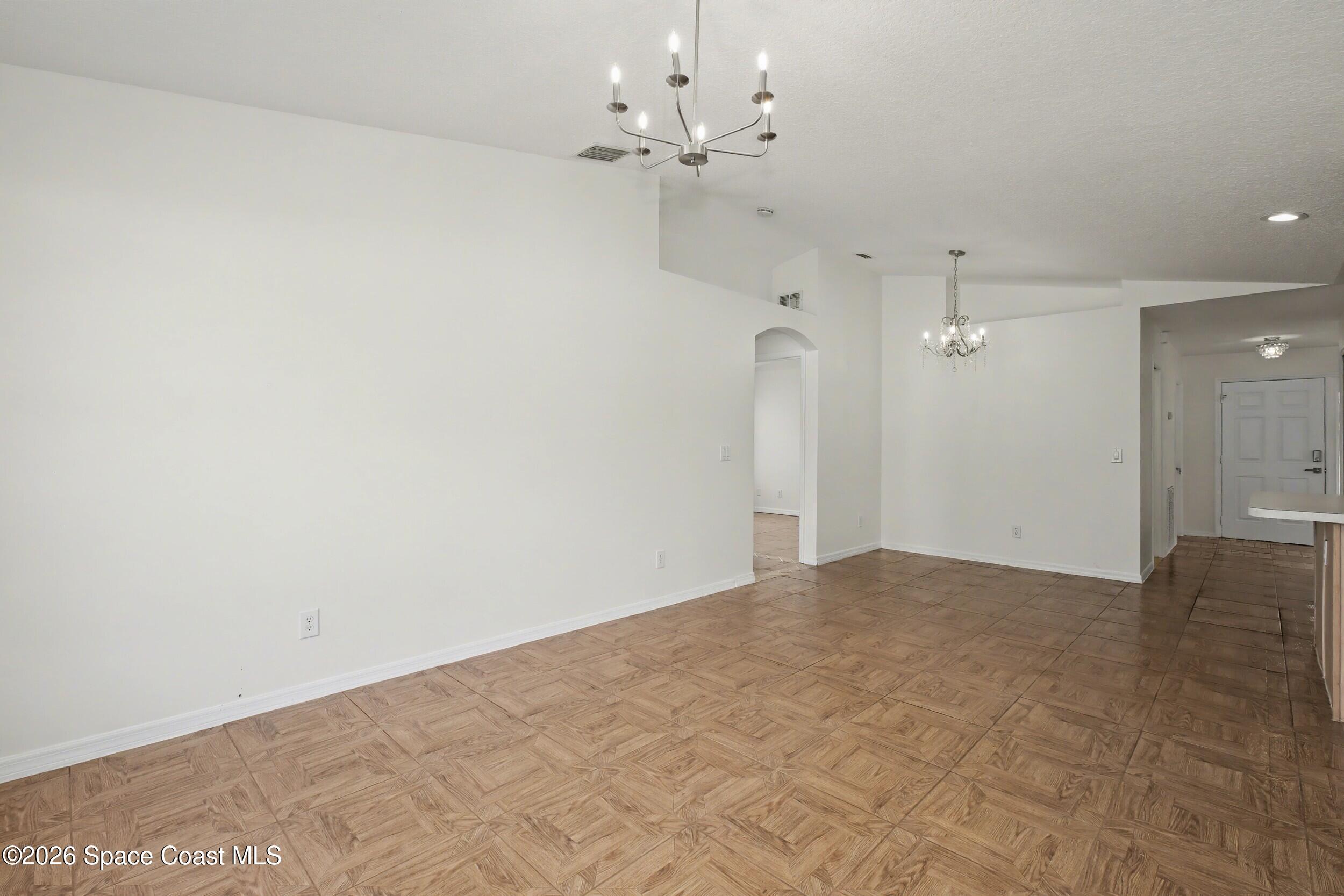 1175 Altamira Street Palm Bay, FL 32907 - Photo 12 of 37 a view of a big room with a chandelier fan