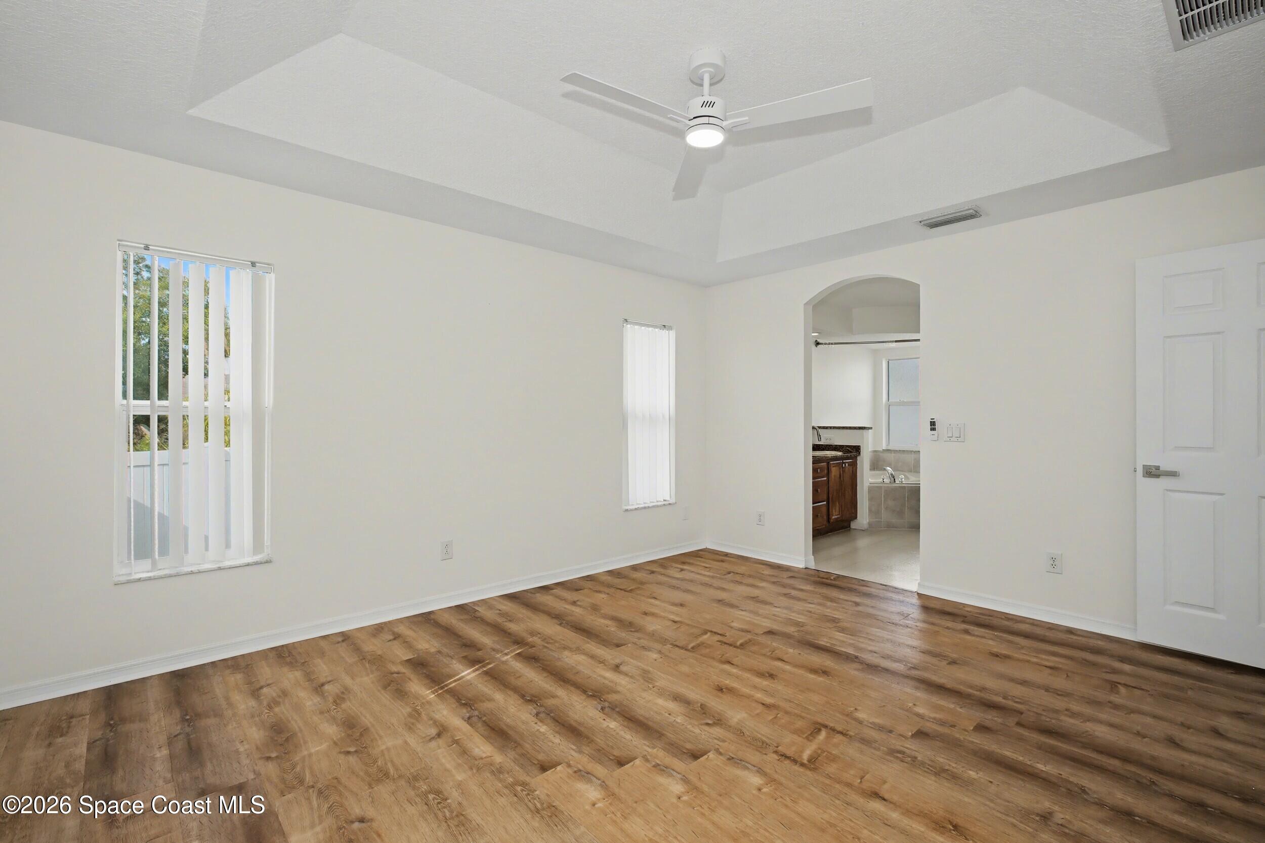 1175 Altamira Street Palm Bay, FL 32907 - Photo 19 of 37 a view of empty room with wooden floor and window