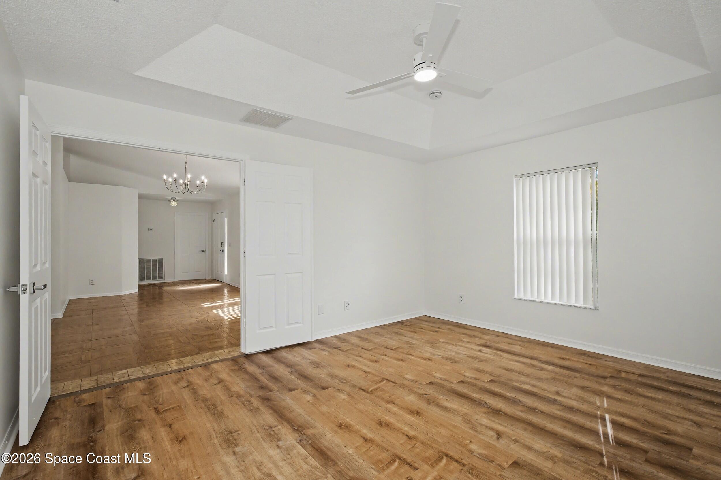 1175 Altamira Street Palm Bay, FL 32907 - Photo 20 of 37 wooden floor in an empty room with a window
