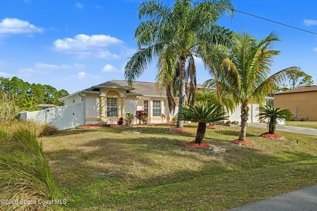 a view of a house with swimming pool and a yard