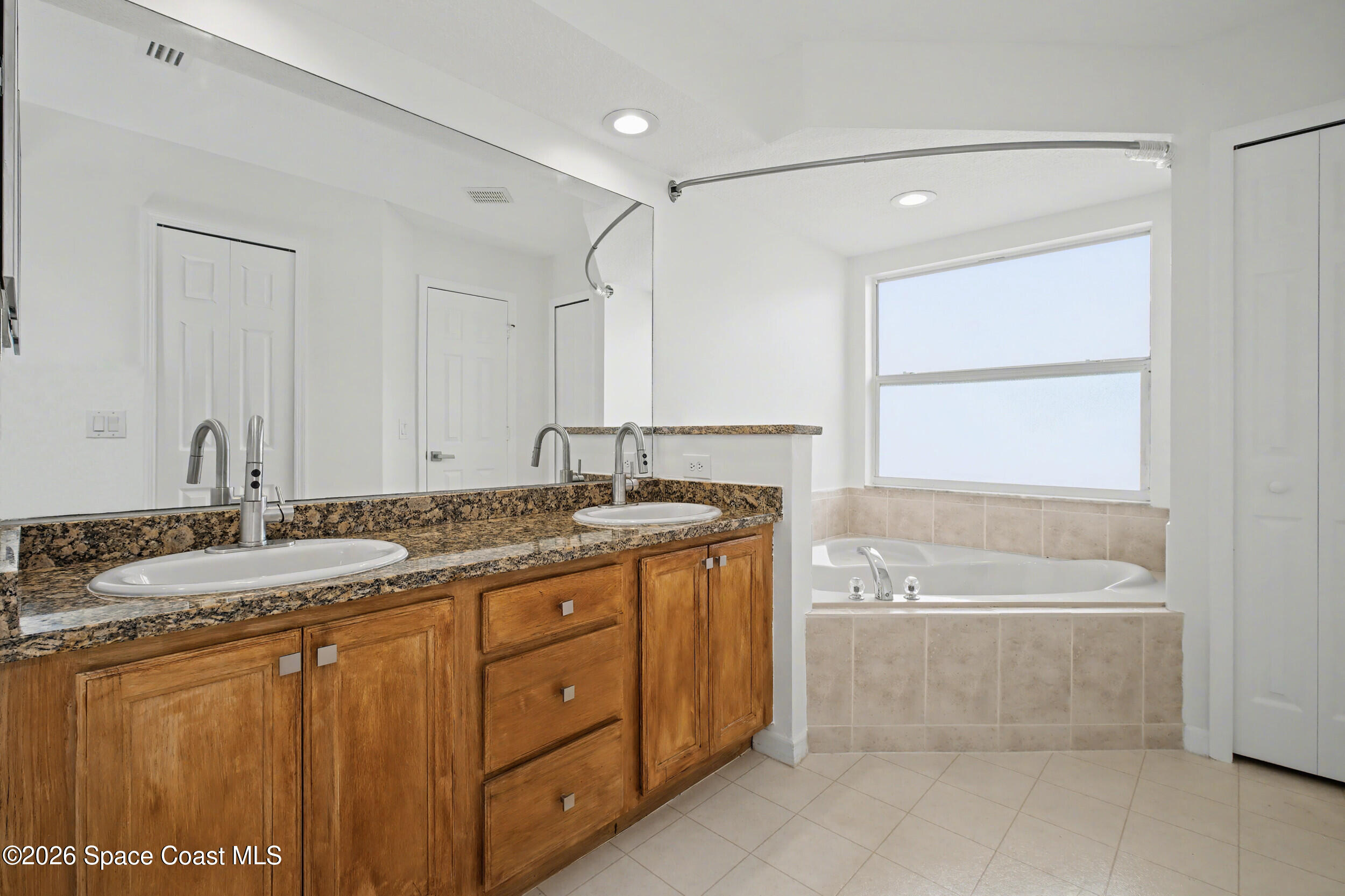 1175 Altamira Street Palm Bay, FL 32907 - Photo 21 of 37 a bathroom with a granite countertop sink mirror and a
