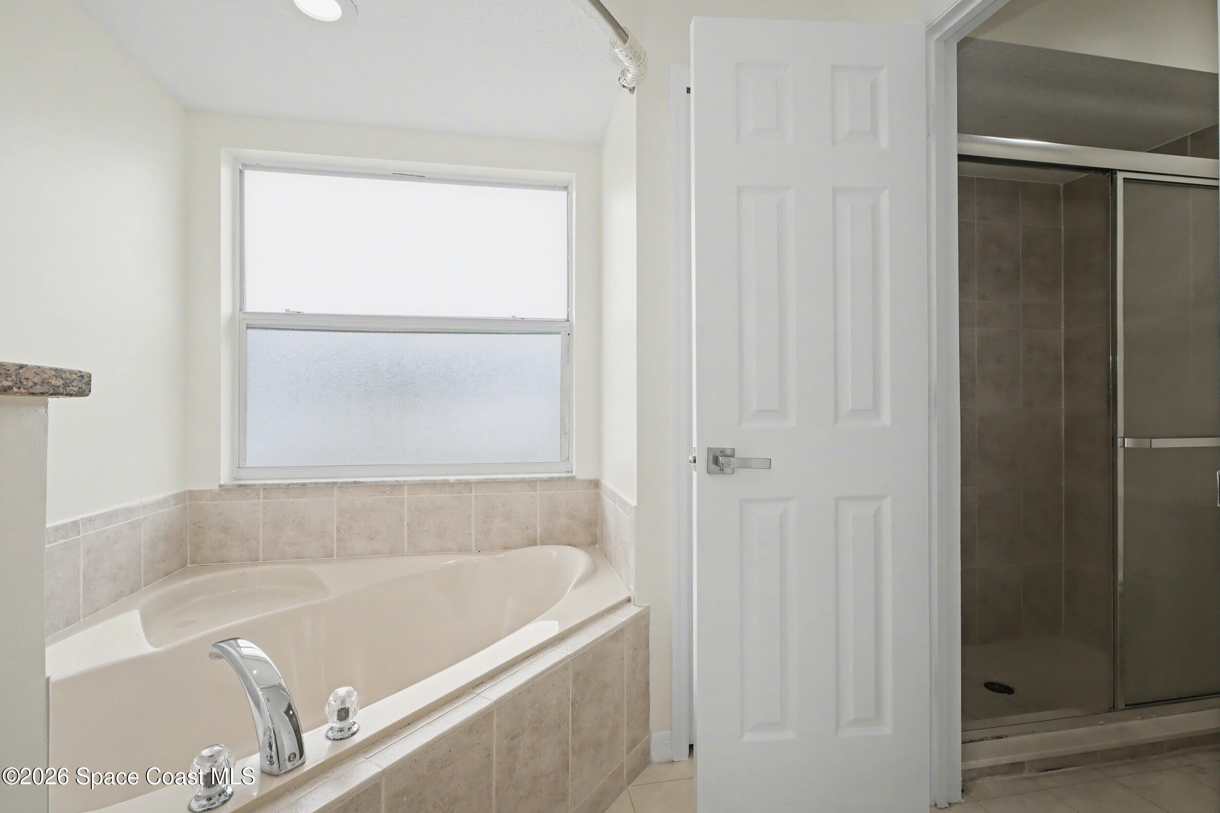 1175 Altamira Street Palm Bay, FL 32907 - Photo 22 of 37 a bathroom with a bathtub and a shower