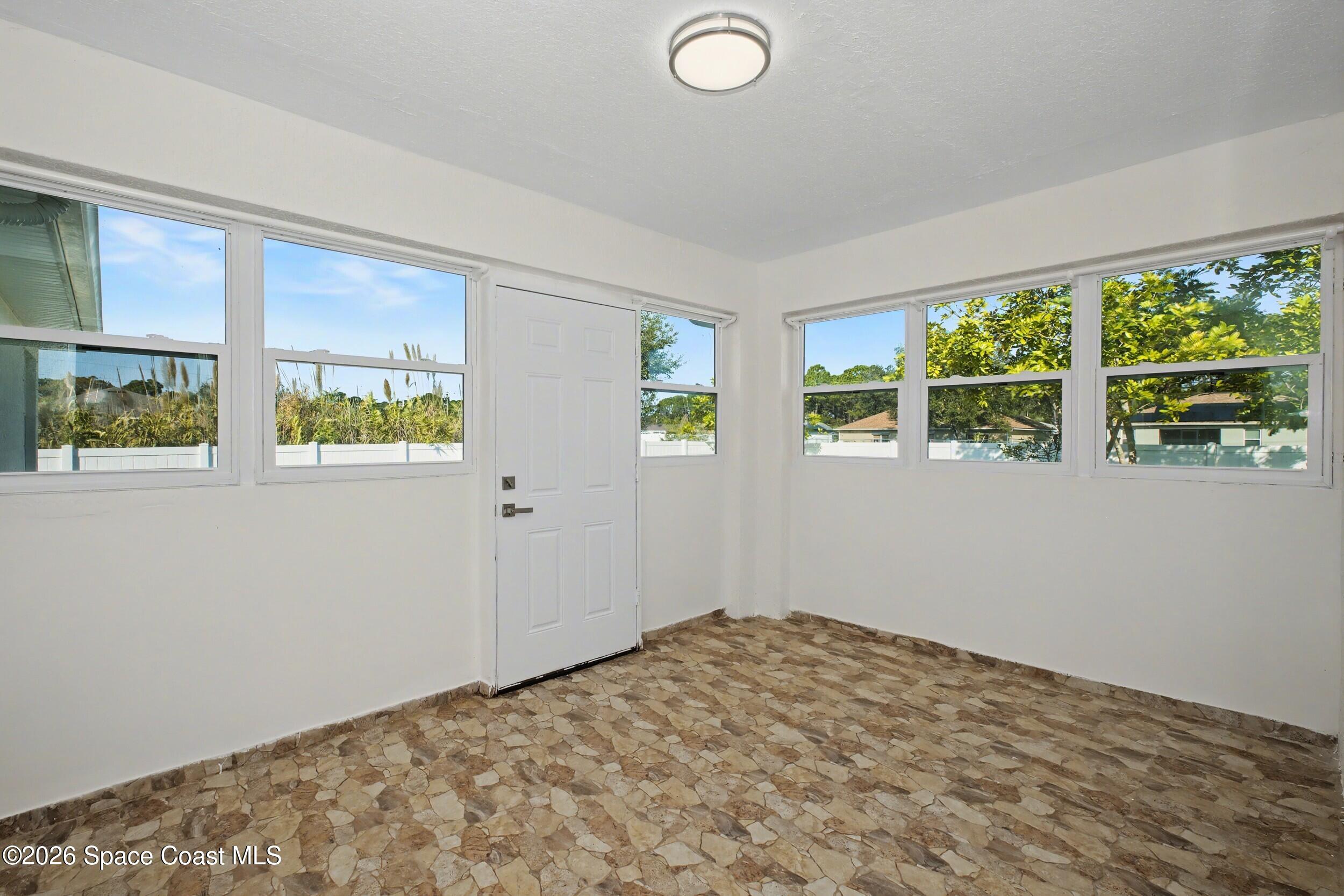 1175 Altamira Street Palm Bay, FL 32907 - Photo 29 of 37 a view of a bedroom with wooden floor and windows