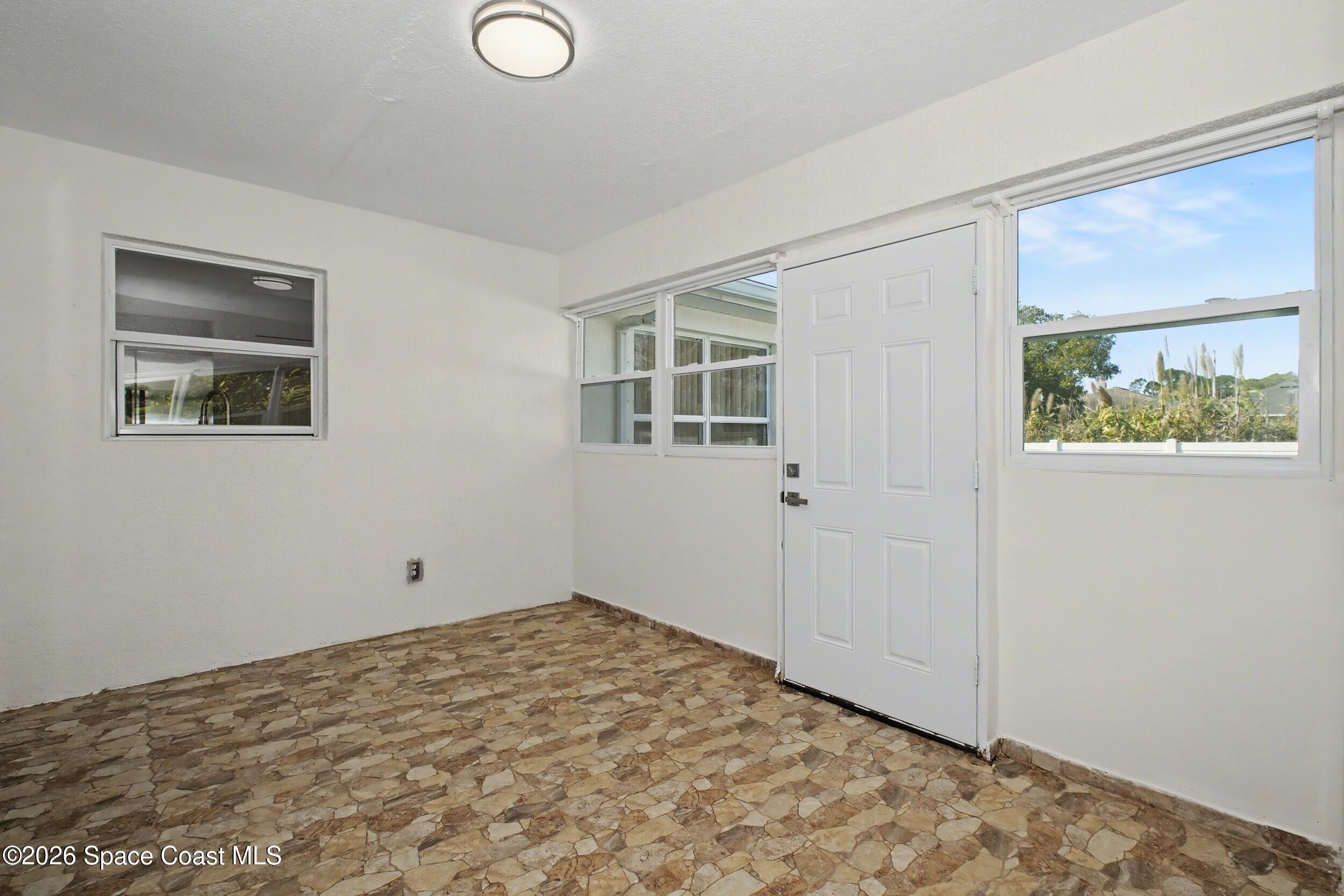 1175 Altamira Street Palm Bay, FL 32907 - Photo 31 of 37 a view of empty room with window and wooden floor