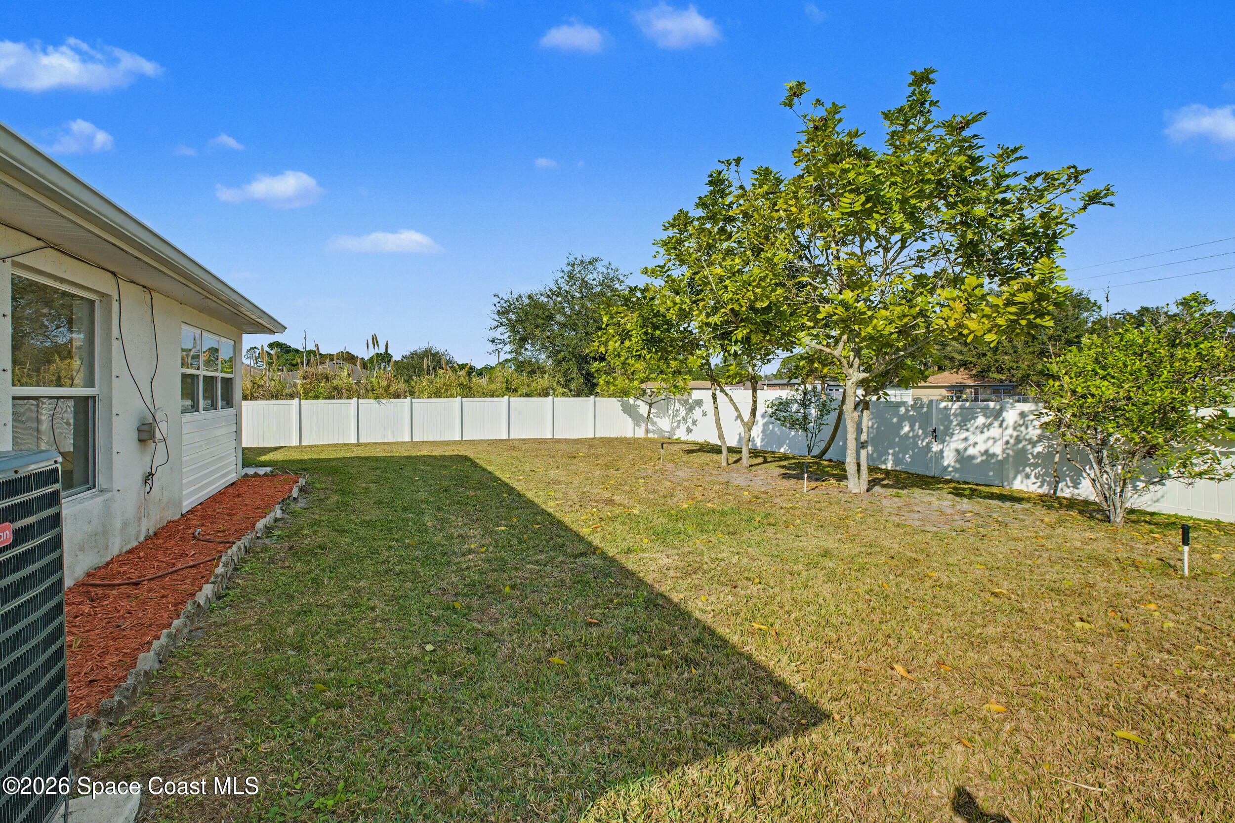 1175 Altamira Street Palm Bay, FL 32907 - Photo 33 of 37 a view of backyard with swimming pool and seating space