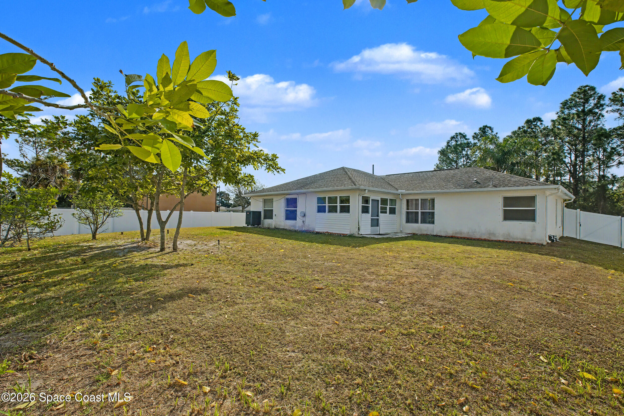 1175 Altamira Street Palm Bay, FL 32907 - Photo 34 of 37 a front view of a house with a garden