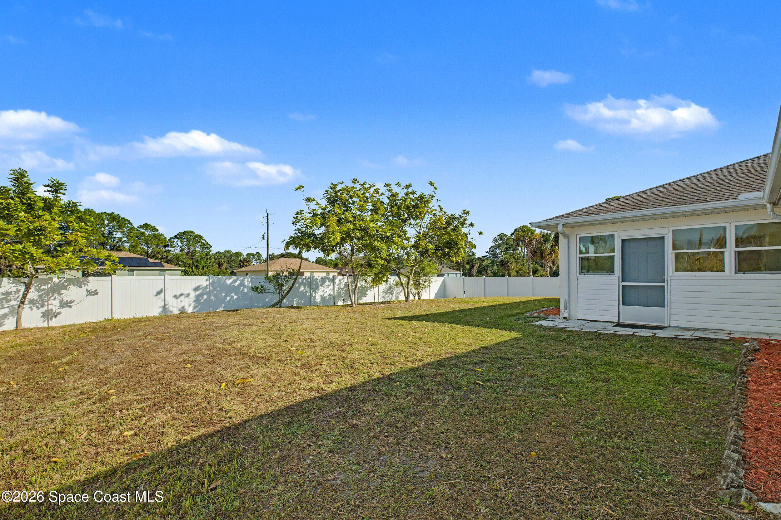 1175 Altamira Street Palm Bay, FL 32907 - Photo 36 of 37 a view of a house with a big yard