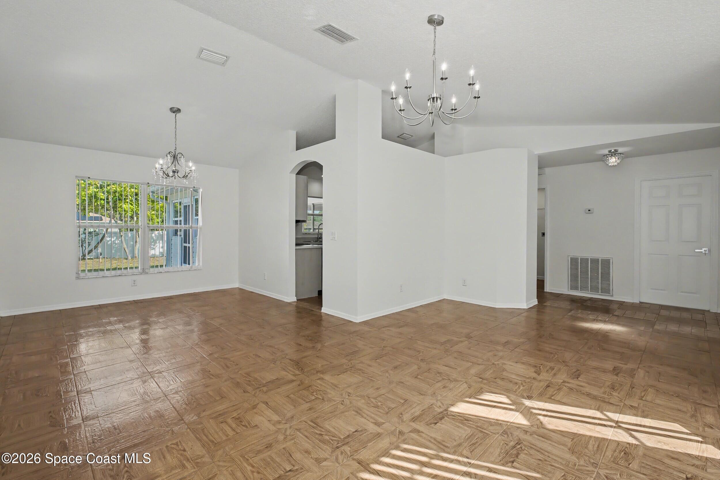 1175 Altamira Street Palm Bay, FL 32907 - Photo 6 of 37 a view of a chandelier in big room and chandelier