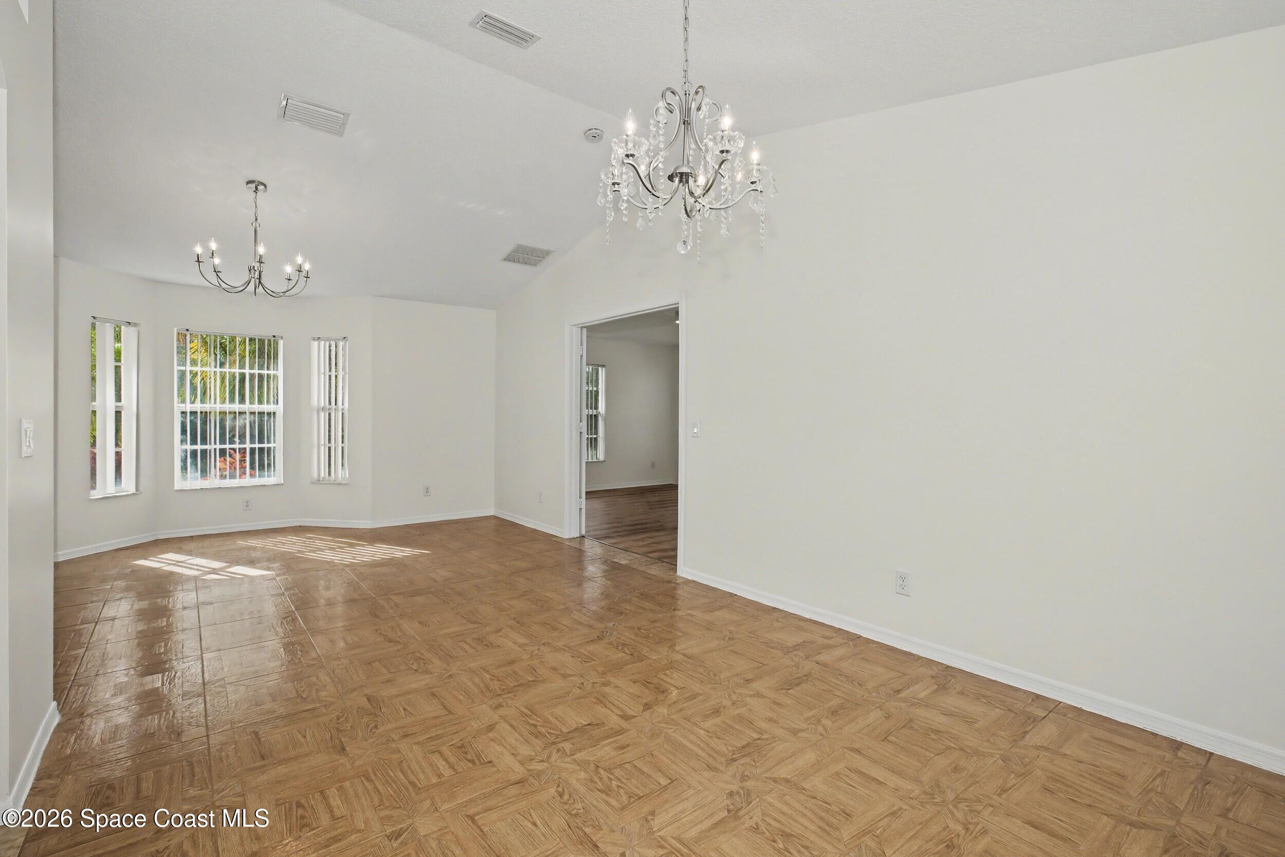 1175 Altamira Street Palm Bay, FL 32907 - Photo 8 of 37 a view of an empty room with chandelier