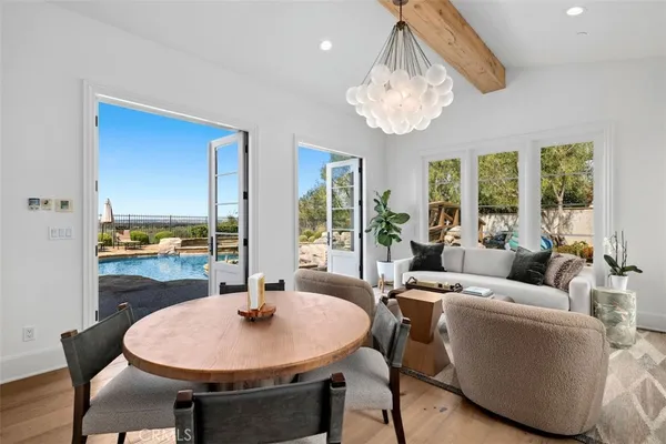 a living room with furniture a table and a large window