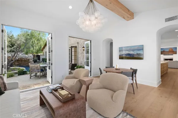 a living room with furniture and large windows
