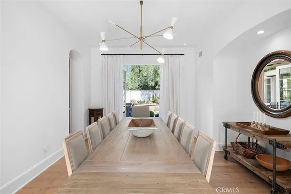 a living room with furniture a window and a chandelier