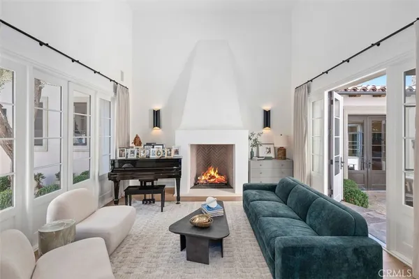 a living room with furniture fireplace and a large window