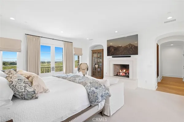 a spacious bedroom with a large bed and a fireplace