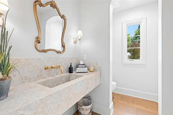 a bedroom with a bed and a dresser with mirror