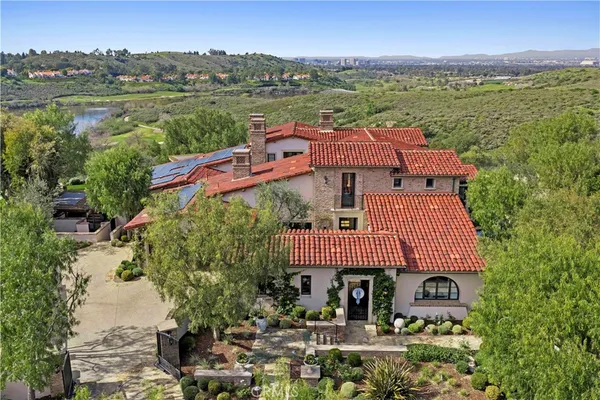 an aerial view of house with yard swimming pool and mountains