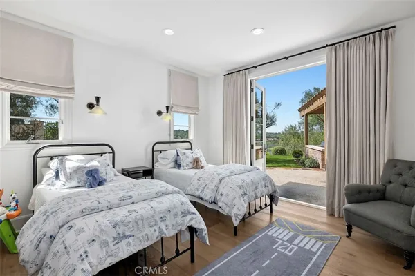 a bedroom with two beds and a large window