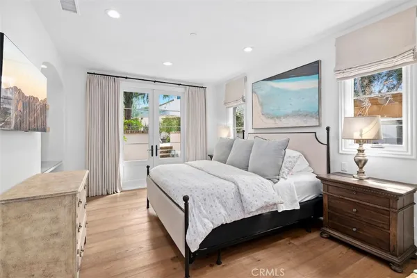 a bedroom with a bed and a dresser with mirror