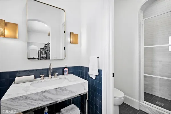 a bathroom with a granite countertop sink toilet and shower