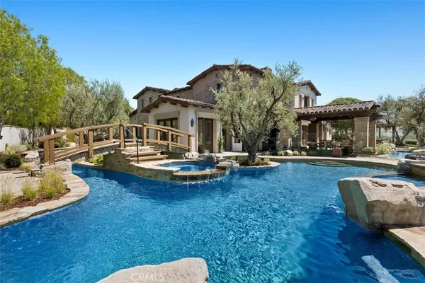 a view of a house with swimming pool and porch