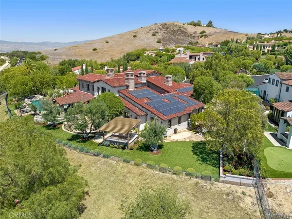 an aerial view of residential houses with outdoor space and street view