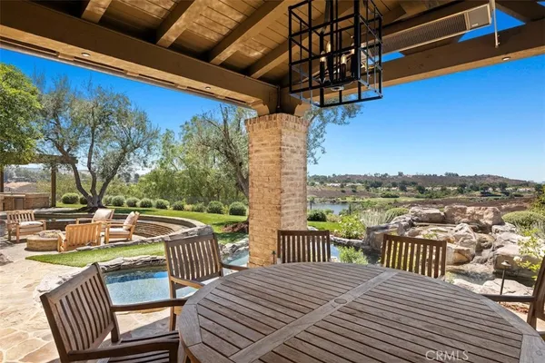 a view of a balcony with wooden floor and outdoor seating