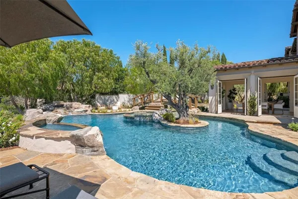 a view of a backyard with plants and a patio
