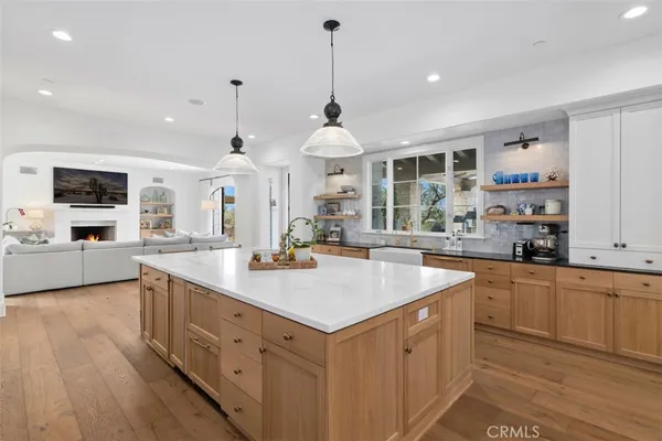 a kitchen with sink cabinets and living room view