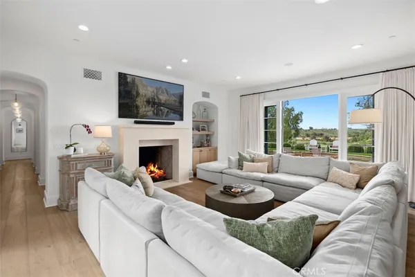 a living room with furniture a window and a chandelier